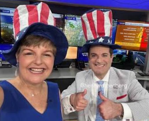 Jennifer in patriotic coverage with co-anchor wearing Uncle Sam hats