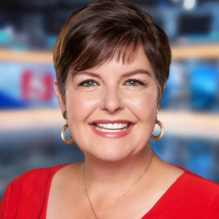 Jennifer Kraus — NewsChannel 5 anchor studio portrait, wearing a red dress